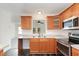 Functional kitchen with wood cabinetry, modern appliances, and an open view to the living area at 325 Bainbridge Cir, Garner, NC 27529