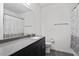 Bright bathroom features a sleek vanity with a gray countertop and a shower with a patterned curtain at 3424 Writt Ct, New Hill, NC 27562