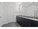 Modern bathroom featuring dual sinks, sleek cabinetry, and stylish fixtures at 3424 Writt Ct, New Hill, NC 27562