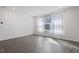 A well-lit bedroom with hardwood floors and a large window at 3424 Writt Ct, New Hill, NC 27562