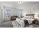 Bright bedroom featuring windows, neutral-toned decor, patterned rug, and stylish furniture at 3424 Writt Ct, New Hill, NC 27562