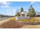 A beautifully landscaped sign welcomes visitors to the Belterra community, set against a blue sky backdrop at 3424 Writt Ct, New Hill, NC 27562
