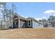 Exterior view of a modern home featuring a screened porch and a well-maintained lawn in a new development at 3424 Writt Ct, New Hill, NC 27562