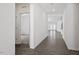 Bright hallway with hardwood floors leading to spacious living areas, showcasing the home's open layout at 3424 Writt Ct, New Hill, NC 27562
