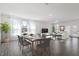 Staged living and dining area with dining table and modern furniture at 3424 Writt Ct, New Hill, NC 27562