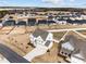 An aerial view showcases a new construction neighborhood with modern homes and white fences in a meticulously planned community at 350 Arlie Ln, Lillington, NC 27546