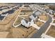 Aerial view of a neighborhood featuring pristine homes with white fences, manicured lawns, and inviting curb appeal at 350 Arlie Ln, Lillington, NC 27546