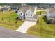 Aerial view of a two-story home with a three-car garage, large yard, and neighborhood setting at 350 Arlie Ln, Lillington, NC 27546