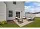 This backyard includes green grass, outdoor seating, and white siding at 350 Arlie Ln, Lillington, NC 27546