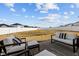 Large, grassy backyard with white fence and patio furniture seating area at 350 Arlie Ln, Lillington, NC 27546