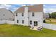This backyard features green grass, white siding, and a patio with seating at 350 Arlie Ln, Lillington, NC 27546
