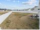 Large fenced backyard with some furniture and view of surrounding houses at 350 Arlie Ln, Lillington, NC 27546