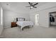 Spacious bedroom with carpet, tray ceiling, bedside tables and a view of the bathroom at 350 Arlie Ln, Lillington, NC 27546