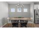 Dining area with modern chandelier, stainless steel appliances, and wood floors at 350 Arlie Ln, Lillington, NC 27546