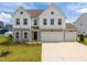 Charming two-story home featuring stone accents, white siding, a welcoming entrance, and manicured lawn at 350 Arlie Ln, Lillington, NC 27546