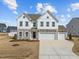 Beautiful two-story home with stone accents and a three-car garage at 350 Arlie Ln, Lillington, NC 27546