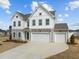 Charming two-story home with a three-car garage and well-manicured landscaping at 350 Arlie Ln, Lillington, NC 27546