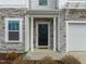 Charming front door of townhome with stone facade and black trim at 350 Arlie Ln, Lillington, NC 27546