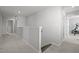 Upstairs hallway with a wooden banister and carpeted floors at 350 Arlie Ln, Lillington, NC 27546