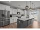 Modern kitchen with stainless steel appliances, island with pendant lights, and ample cabinet space at 350 Arlie Ln, Lillington, NC 27546