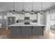 Bright kitchen featuring white cabinetry, stainless steel appliances, and a large island with quartz countertops at 350 Arlie Ln, Lillington, NC 27546