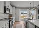 Bright kitchen featuring white cabinetry, stainless steel appliances, and a large island with quartz countertops at 350 Arlie Ln, Lillington, NC 27546