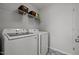 Functional laundry room featuring a washer, dryer and shelving for storage at 350 Arlie Ln, Lillington, NC 27546
