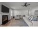 Spacious living room featuring a fireplace with a white mantel, a mounted TV, and sectional sofa at 350 Arlie Ln, Lillington, NC 27546