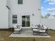 Cozy patio with modern outdoor seating and white privacy fence, perfect for relaxing or entertaining guests at 350 Arlie Ln, Lillington, NC 27546