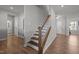 Interior view of a wood staircase with white painted risers and a dark stained handrail at 350 Arlie Ln, Lillington, NC 27546