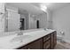 Bathroom with dual sinks, large vanity, ample lighting, and stylish fixtures at 363 Grey Hawk Dr, Garner, NC 27529