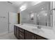 Bathroom with double vanity, large mirror, brown cabinets, and separate shower and tub at 363 Grey Hawk Dr, Garner, NC 27529