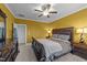 Bedroom features a decorative headboard, ceiling fan, large window, and two side tables at 363 Grey Hawk Dr, Garner, NC 27529