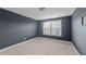 Empty bedroom with carpeted floors, a large window, and neutral walls at 363 Grey Hawk Dr, Garner, NC 27529
