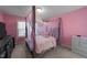 Pink bedroom with canopy bed, dresser, and a large window at 363 Grey Hawk Dr, Garner, NC 27529