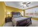 Well-lit bedroom boasts a decorative headboard, large window, and ceiling fan at 363 Grey Hawk Dr, Garner, NC 27529