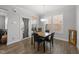 Cozy dining area with abundant natural light, wood flooring, and minimalist decor making it an inviting place to gather at 363 Grey Hawk Dr, Garner, NC 27529