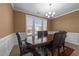 Traditional dining room featuring a wood table, chandelier, and large window with natural light at 363 Grey Hawk Dr, Garner, NC 27529