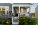 Inviting front porch with classic white railing, stone columns, and decorative details that give it curb appeal at 363 Grey Hawk Dr, Garner, NC 27529