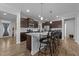 Modern kitchen featuring a large center island with granite countertops, stainless steel appliances, and stylish pendant lighting at 363 Grey Hawk Dr, Garner, NC 27529