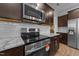 Close-up showcasing stainless appliances, granite countertops, and modern cabinetry, adding luxury to the cooking space at 363 Grey Hawk Dr, Garner, NC 27529