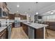 Spacious kitchen with island seating, stainless steel appliances, and an open layout seamlessly connecting to other living spaces at 363 Grey Hawk Dr, Garner, NC 27529