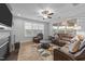 Comfortable living room with a fireplace, plush seating, and large windows offering an inviting space for relaxation at 363 Grey Hawk Dr, Garner, NC 27529