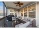 Relaxing screened porch with comfortable seating, ceiling fan and grill at 363 Grey Hawk Dr, Garner, NC 27529
