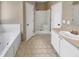 Bright bathroom with bathtub, separate shower and white vanity at 4023 Cashew Dr, Raleigh, NC 27616
