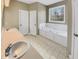Bathroom with a white vanity, large tub with jets, and tiled floor at 4023 Cashew Dr, Raleigh, NC 27616