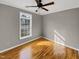 Simple bedroom features hardwood floors, a ceiling fan, and natural light at 4023 Cashew Dr, Raleigh, NC 27616