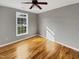 Neutral bedroom features hardwood floors, grey walls, and a bright window at 4023 Cashew Dr, Raleigh, NC 27616