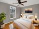 Cozy bedroom featuring a ceiling fan, hardwood floors, and a bright window at 4023 Cashew Dr, Raleigh, NC 27616