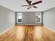 Large, neutral bedroom featuring wood floors, gray walls, and windows for natural light at 4023 Cashew Dr, Raleigh, NC 27616